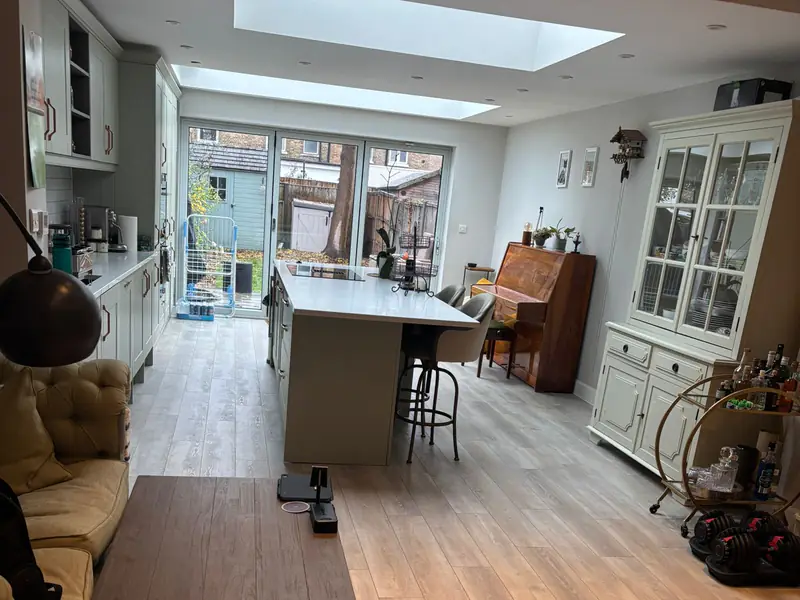 Open-plan kitchen extension with an island, skylights and garden doors